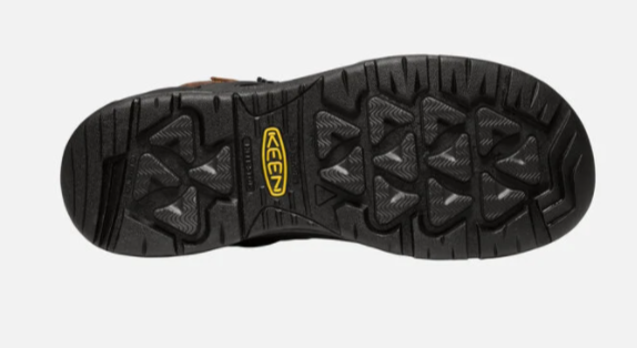 Keen Men's Dover 6 inch waterproof boots with carbon-fiber toe in dark earth and black. The boots have lace-up closure and a rubber outsole.  Bottom view showing outsole. 