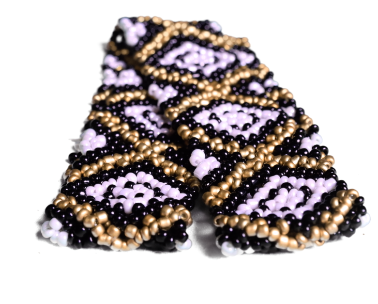 This beaded hat band features stretch so it fits all hats. It is Black, Gold, and White.  Close up view of band off hat