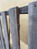 This cowhide and leather crossbody bag has fringe side details and a embossed Turquoise panel along the top front of the bag. Close up of adjustable removable leather shoulder strap. 