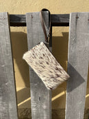 Cowhide wristlet purse in a Coffee Brown solid leather back and a zippered closure. It has a wristlet strap and a removable adjustable shoulder strap. Front View I