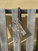 Cowhide wristlet purse in a Coffee Brown solid leather back and a zippered closure. It has a wristlet strap and a removable adjustable shoulder strap. Front View F