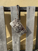 Cowhide wristlet purse in a Coffee Brown solid leather back and a zippered closure. It has a wristlet strap and a removable adjustable shoulder strap. Front View E