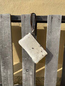 Cowhide wristlet purse in a Coffee Brown solid leather back and a zippered closure. It has a wristlet strap and a removable adjustable shoulder strap. Front View C