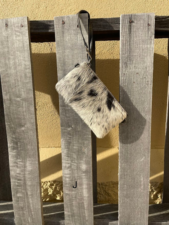 Cowhide wristlet purse in Black leather with a zippered closure. This bag has a wristlet handle or shoulder strap. Front View J