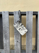 Cowhide wristlet purse in Black leather with a zippered closure. This bag has a wristlet handle or shoulder strap. Front View H