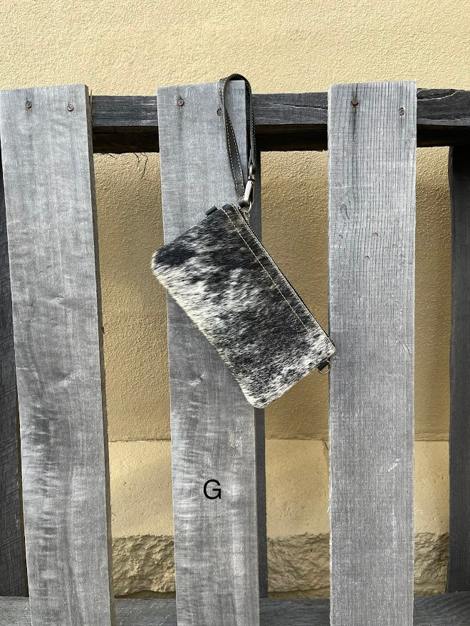 Cowhide wristlet purse in Black leather with a zippered closure. This bag has a wristlet handle or shoulder strap. Front View G