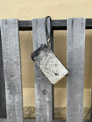 Cowhide wristlet purse in Black leather with a zippered closure. This bag has a wristlet handle or shoulder strap. Front View C