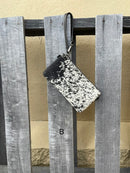 Cowhide wristlet purse in Black leather with a zippered closure. This bag has a wristlet handle or shoulder strap. Front View B