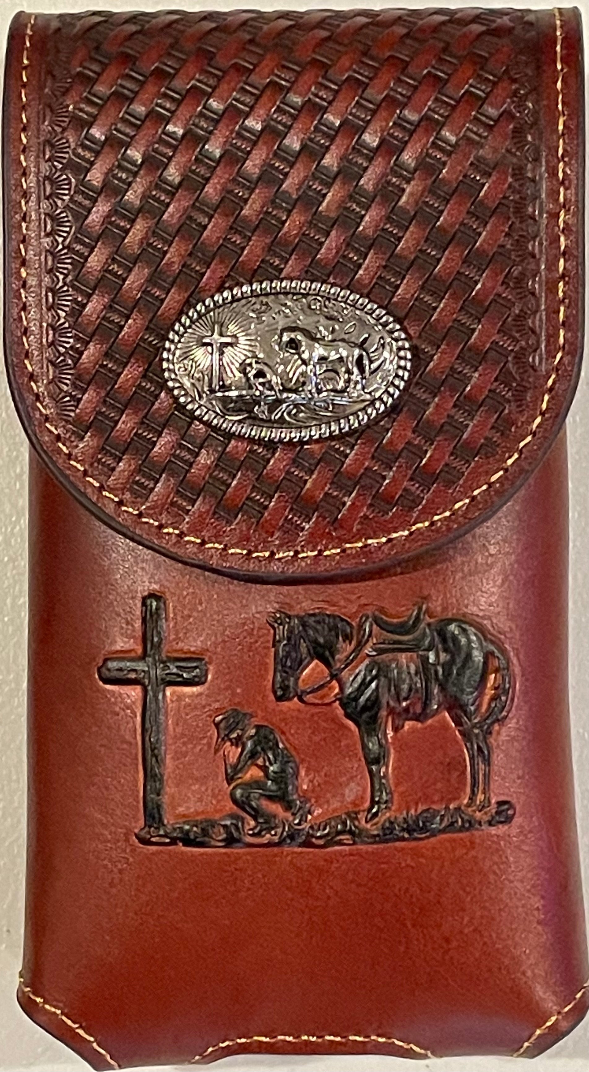 Brown basketweave leather phone case with embossed Praying Cowboy design as well as a Praying Cowboy Concho. 