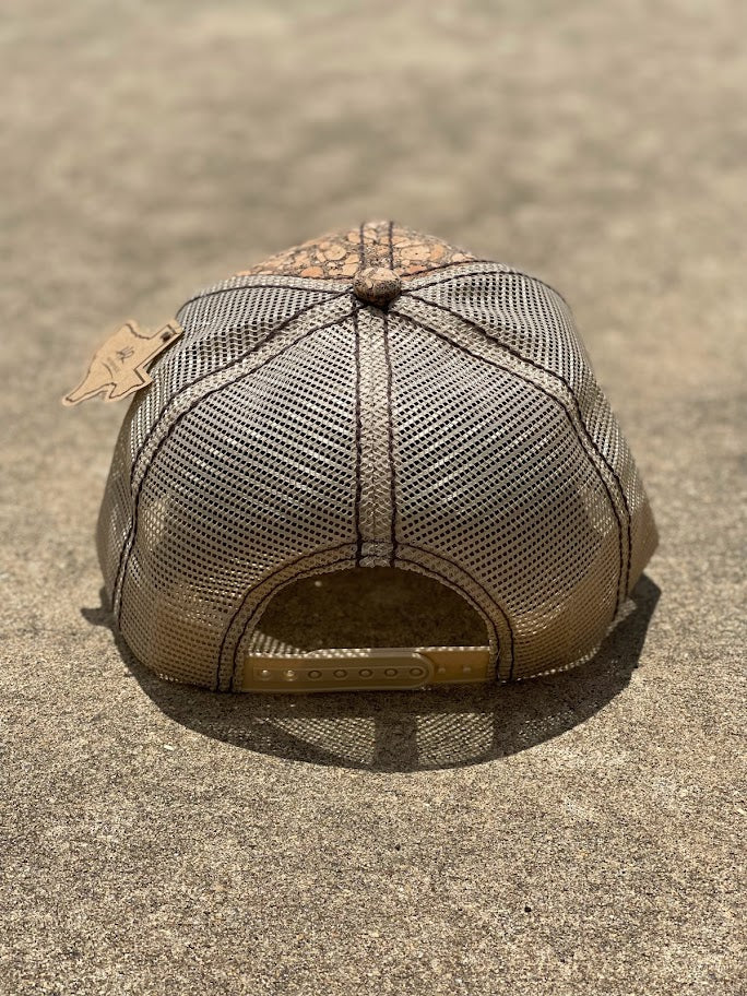A brown cork cap with an metal  American flag Concho on the front, featuring an adjustable fit mesh back.  Rear View 