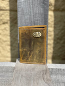 A vintage brown 'Crazy Horse' leather tri-fold wallet with a lab metal concho Front view.