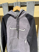 Women's Kimes Ranch Amigo Fleece Hoodie in Charcoal with Black color blocking and an embroidered horn applique at the chest. Front view displayed on a hanger. 