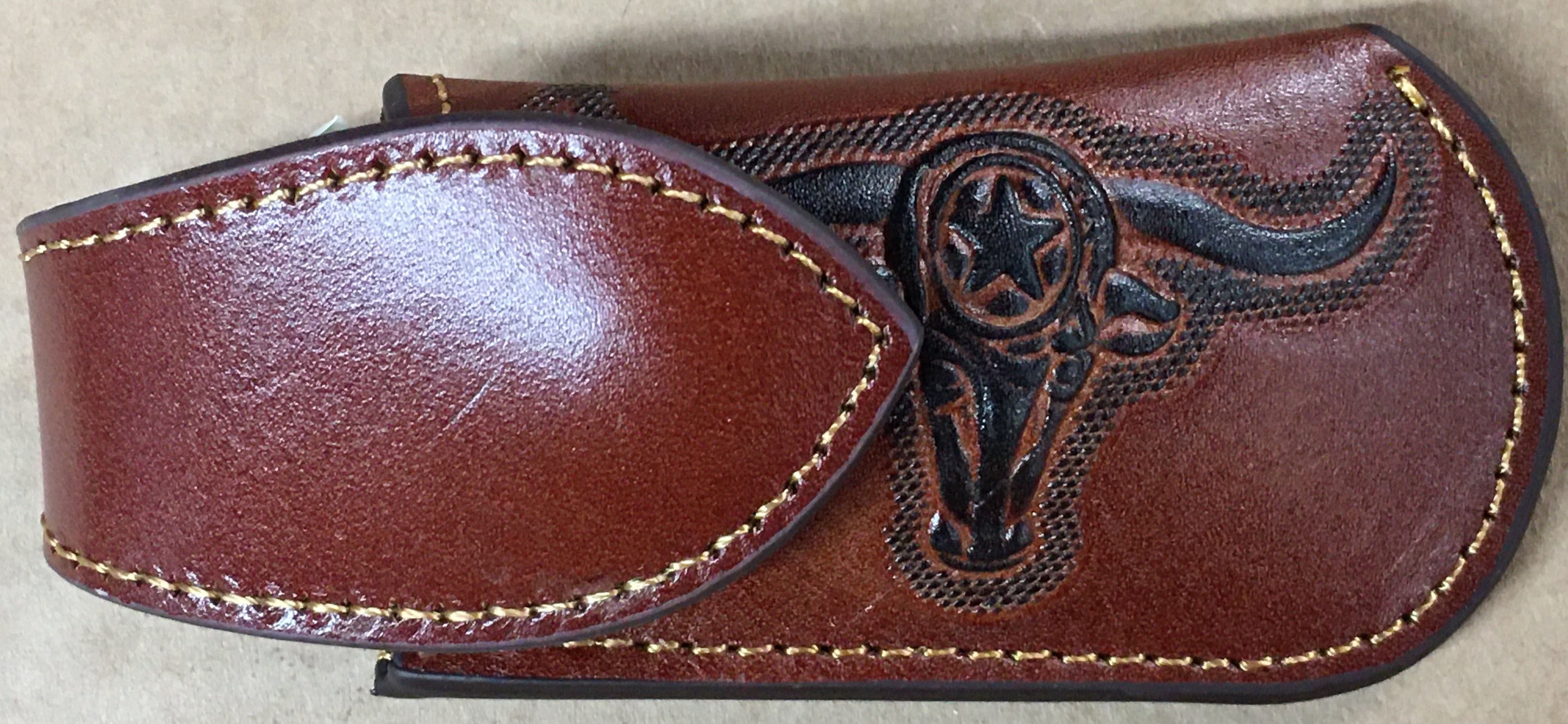 A brown leather knife sheath with a longhorn and star design. Front View