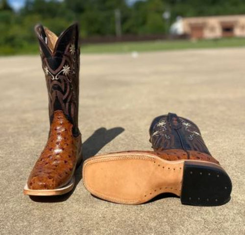 Women's Cowtown boots with a cognac full quill ostrich print, featuring a square toe and decorative stitching on the shaft. Bottom view showing leather outsole. 