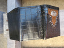 Brown alligator print leather tri-fold wallet featuring an upper hair-on framed section with a cowboy praying at the cross Concho. 