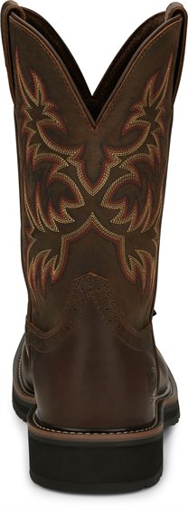 A back view pair of Justin Men's 11" Steel Toe Driller work boots in rugged tan color with a square toe style and decorative stitching. 