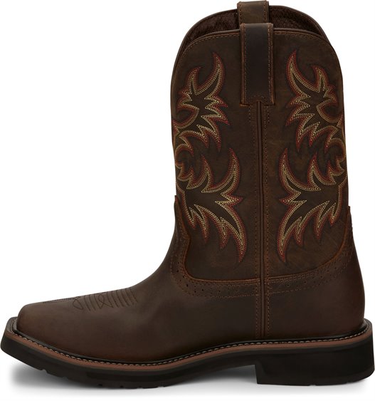 A instep side view pair of Justin Men's 11" Steel Toe Driller work boots in rugged tan color with a square toe style and decorative stitching. 