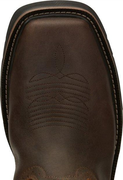 A toe view pair of Justin Men's 11" Steel Toe Driller work boots in rugged tan color with a square toe style and decorative stitching. 