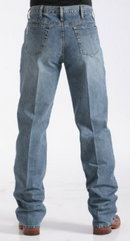 Men's White Label Medium Wash jeans back view showing detail of back pockets, belt loop placement, relaxed fit on seat and leg, stack on boots.