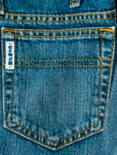 Close-up of back pocket stitching of Cinch White Label jeans.