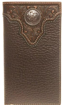 A dark pebbled brown leather wallet with a brown tooled overlay and an ornate silver tone concho on the front.