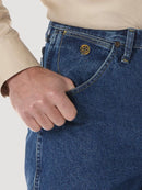 A close-up view of the front pocket of a Wrangler men's George Strait Cowboy Cut relaxed fit jeans showing the top rivets, the coin pocket with logo, and the larger scoop pocket.