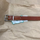 Buckle of chestnut harness leather breast collar tug.