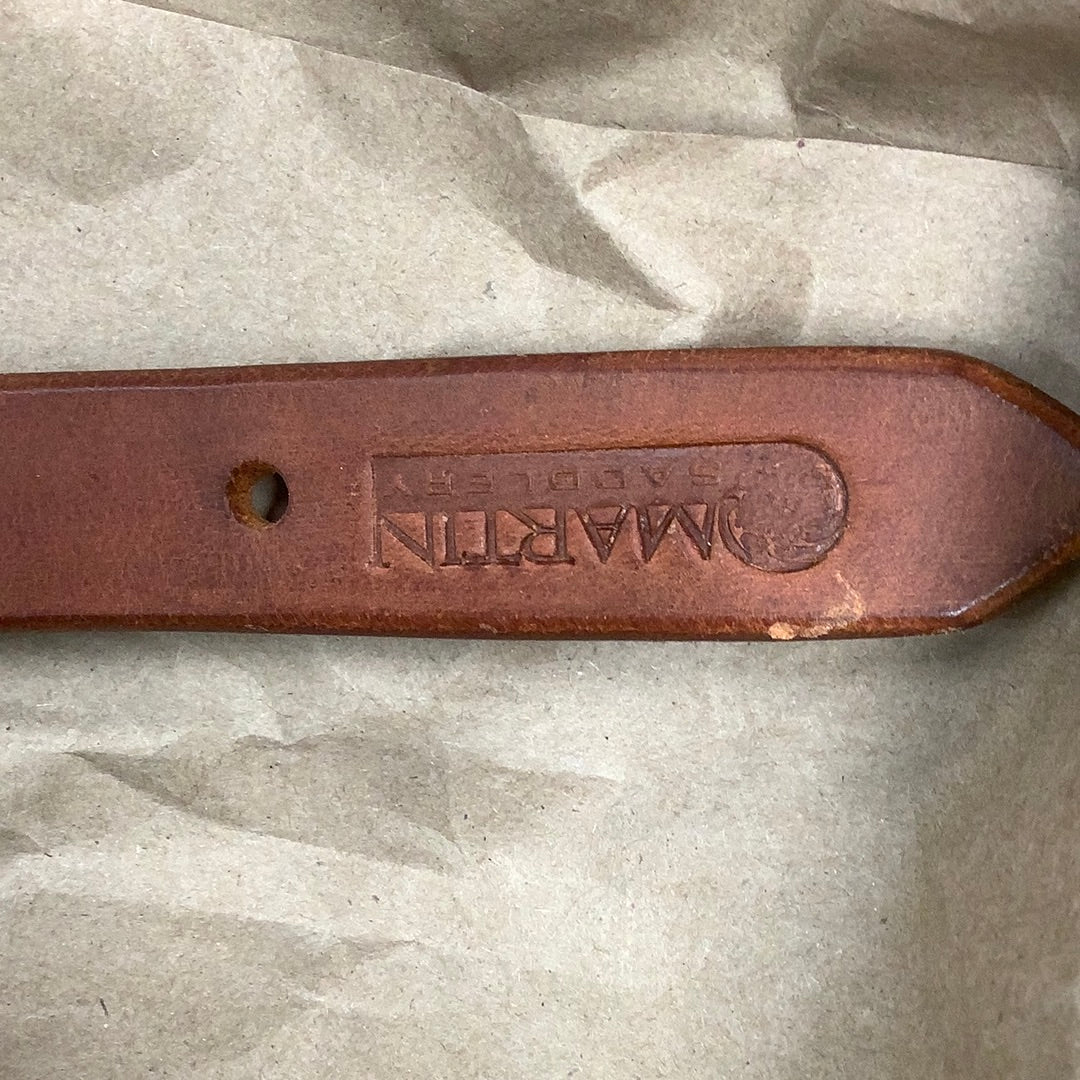 End of Martin Saddlery harness leather breast collar tug showing stamped logo.