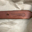 End of Martin Saddlery harness leather breast collar tug showing stamped logo.