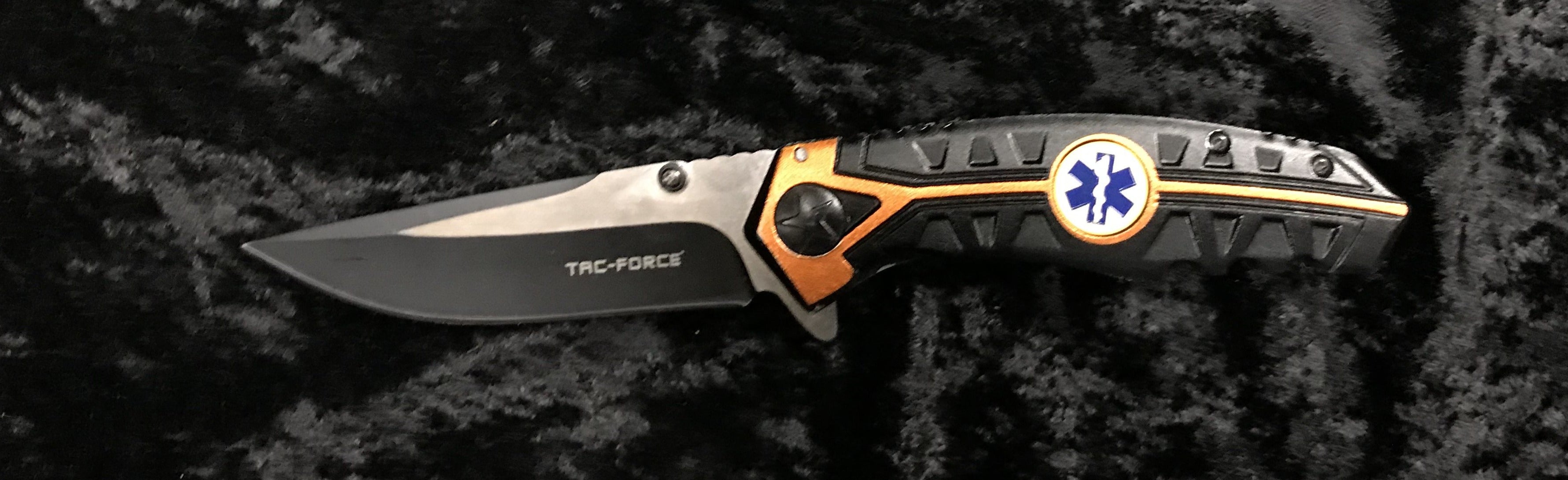 This stainless steel and black knife features a EMT logo on the handle. 