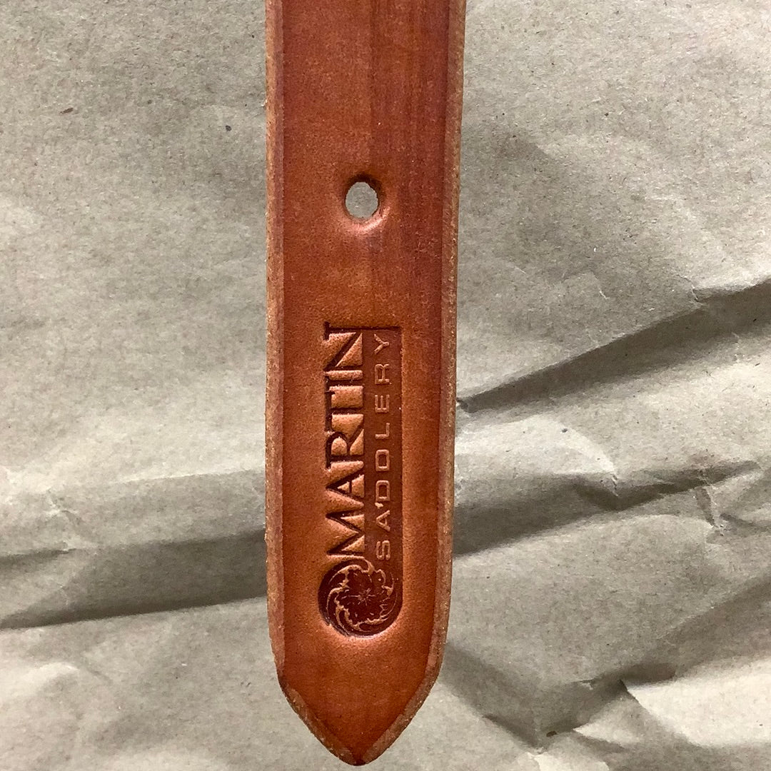 End of Martin Saddlery chestnut harness leather breast collar tug showing stamped logo.