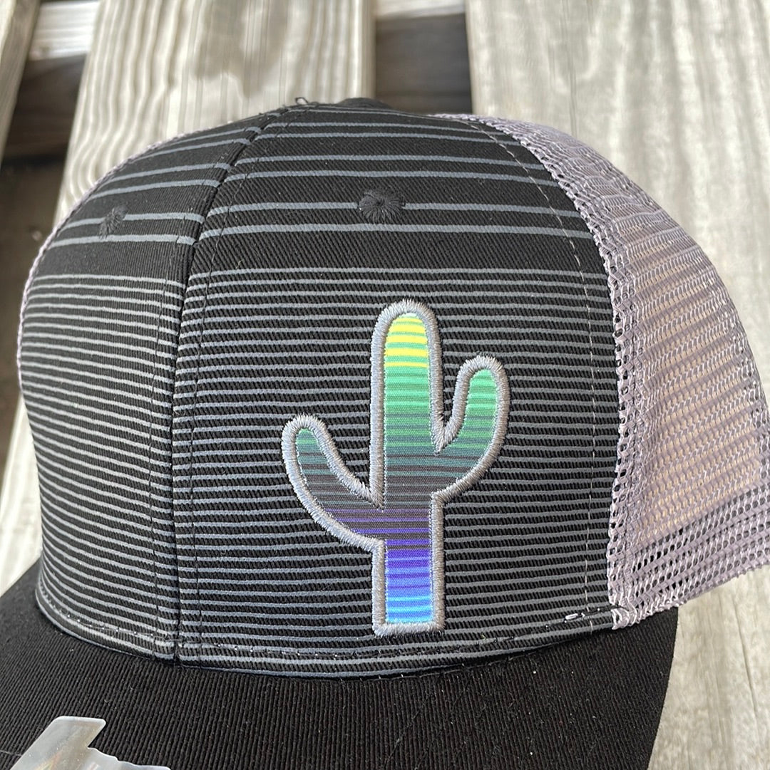 Black trucker cap with Grey stripes, Grey mesh back, a solid black bill and a Serape Cactus Patch. Close up view of patch. 