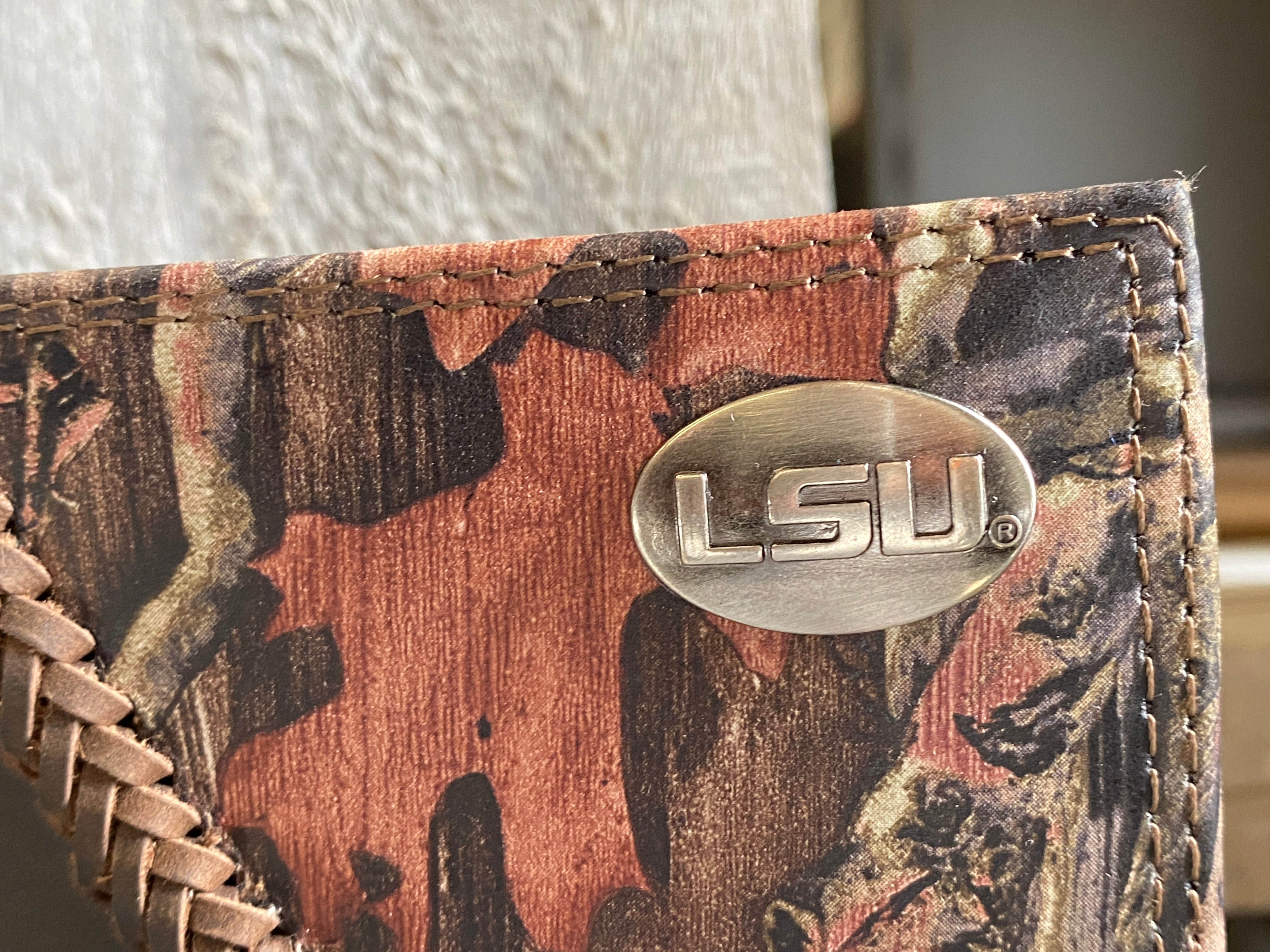 Zep-Pro Louisiana State University Tigers 1/2 Mossy Oak Camo/Brown Leather Trifold Wallet front view focusing on concho.
