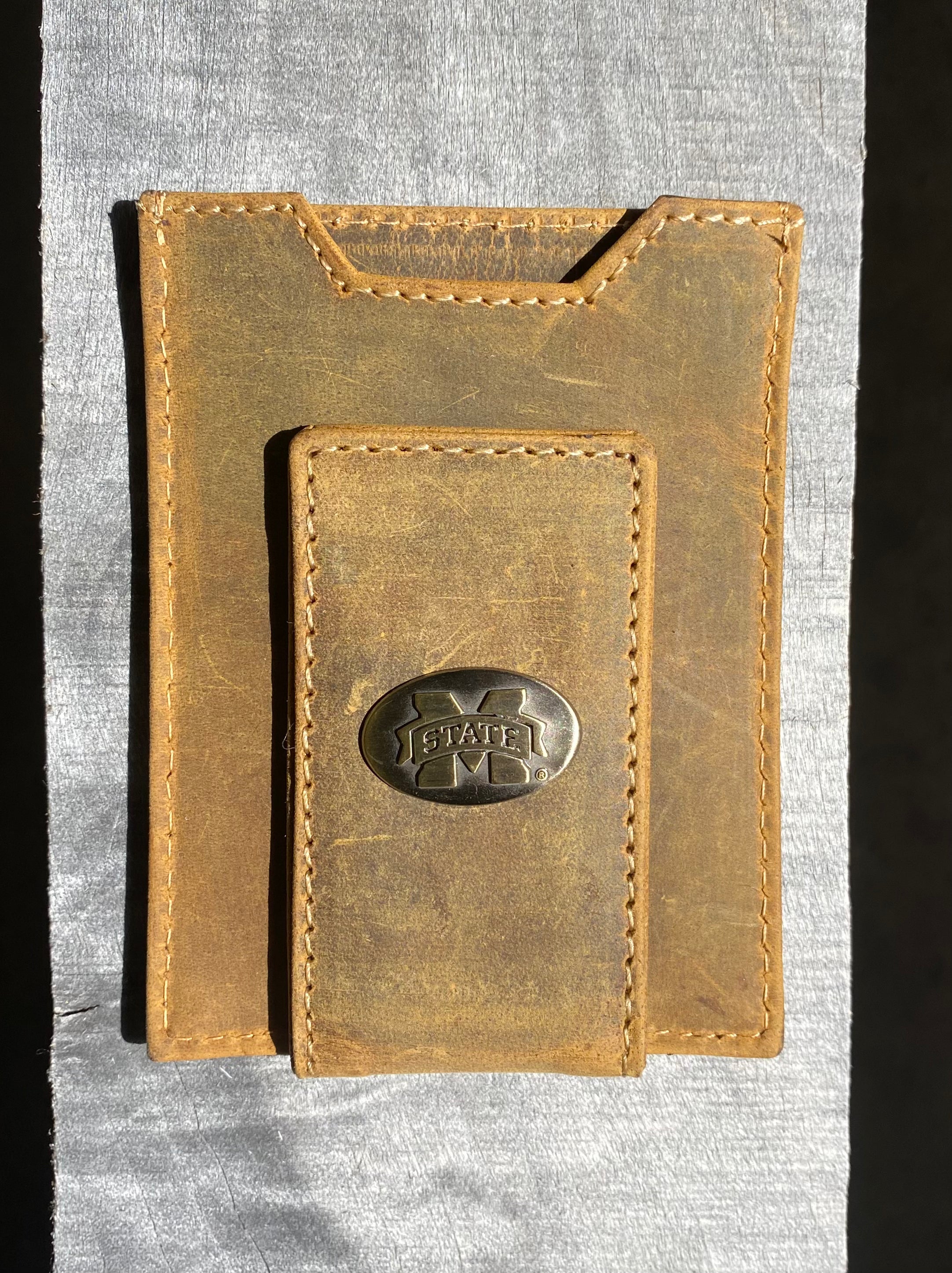 Zep Pro Mississippi State University Bulldogs Vintage Tan Leather Front Pocket Wallet. Front view shows brass  M State concho on cash magnetic closure tab.