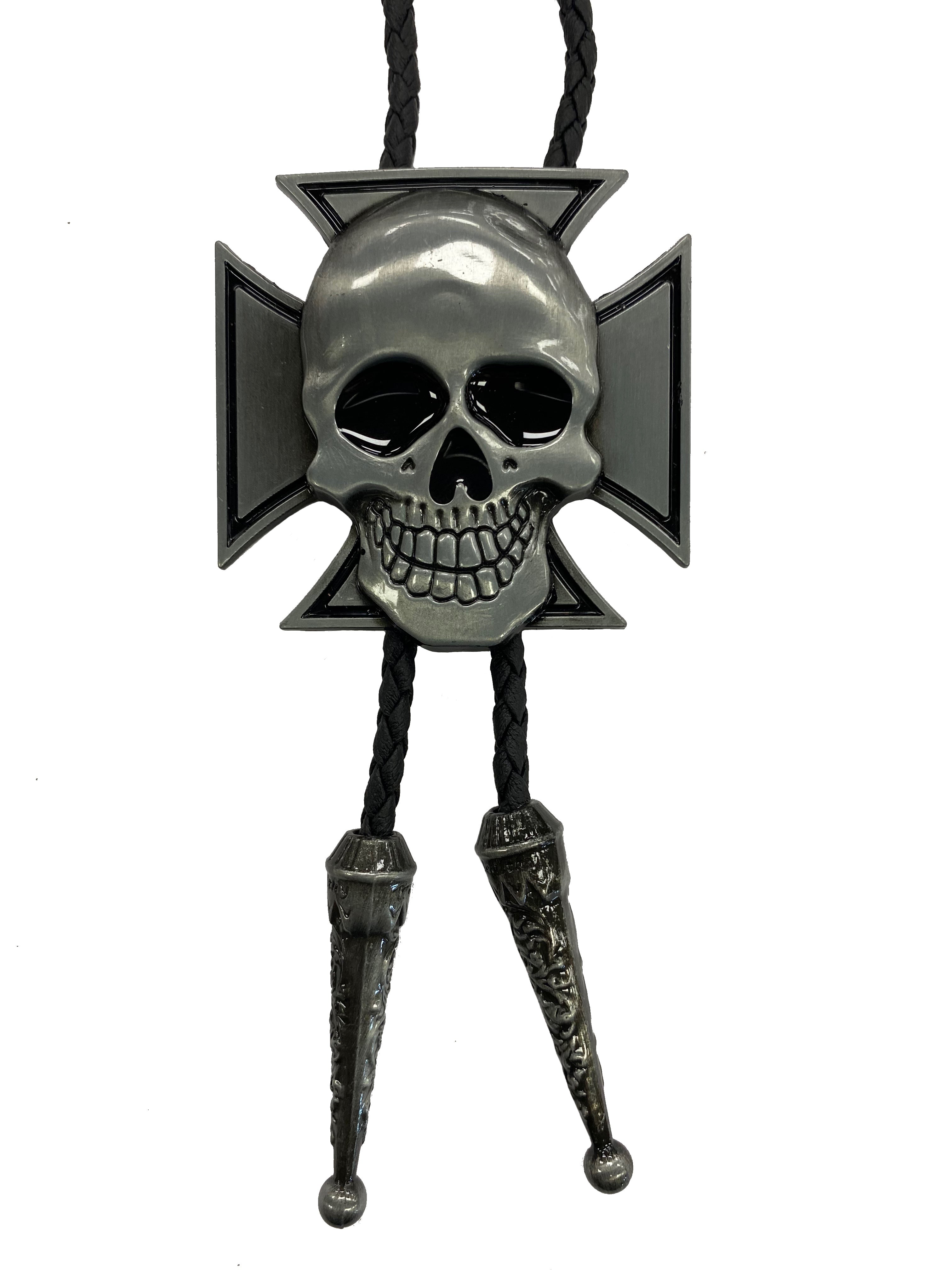 This bolo tie features a skull on a cross background. It has a Black braided cord with metal tips, and it is fully adjustable.