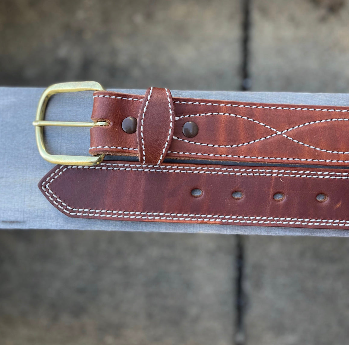 Brass buckle end and holes end shown.