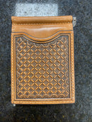 A brown leather money clip wallet with a diamond weave embossed pattern on the front.