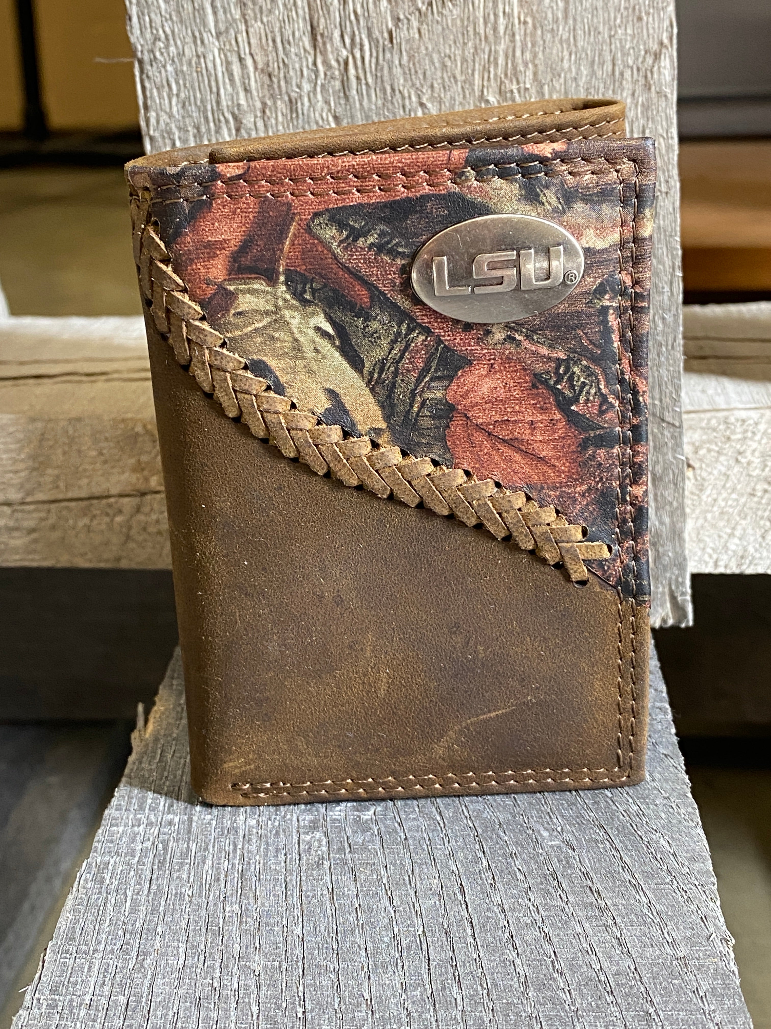 Zep-Pro Louisiana State University Tigers 1/2 Mossy Oak Camo/Brown Leather Trifold Wallet with a brass LSU concho on top right corner of camo leather. Front view