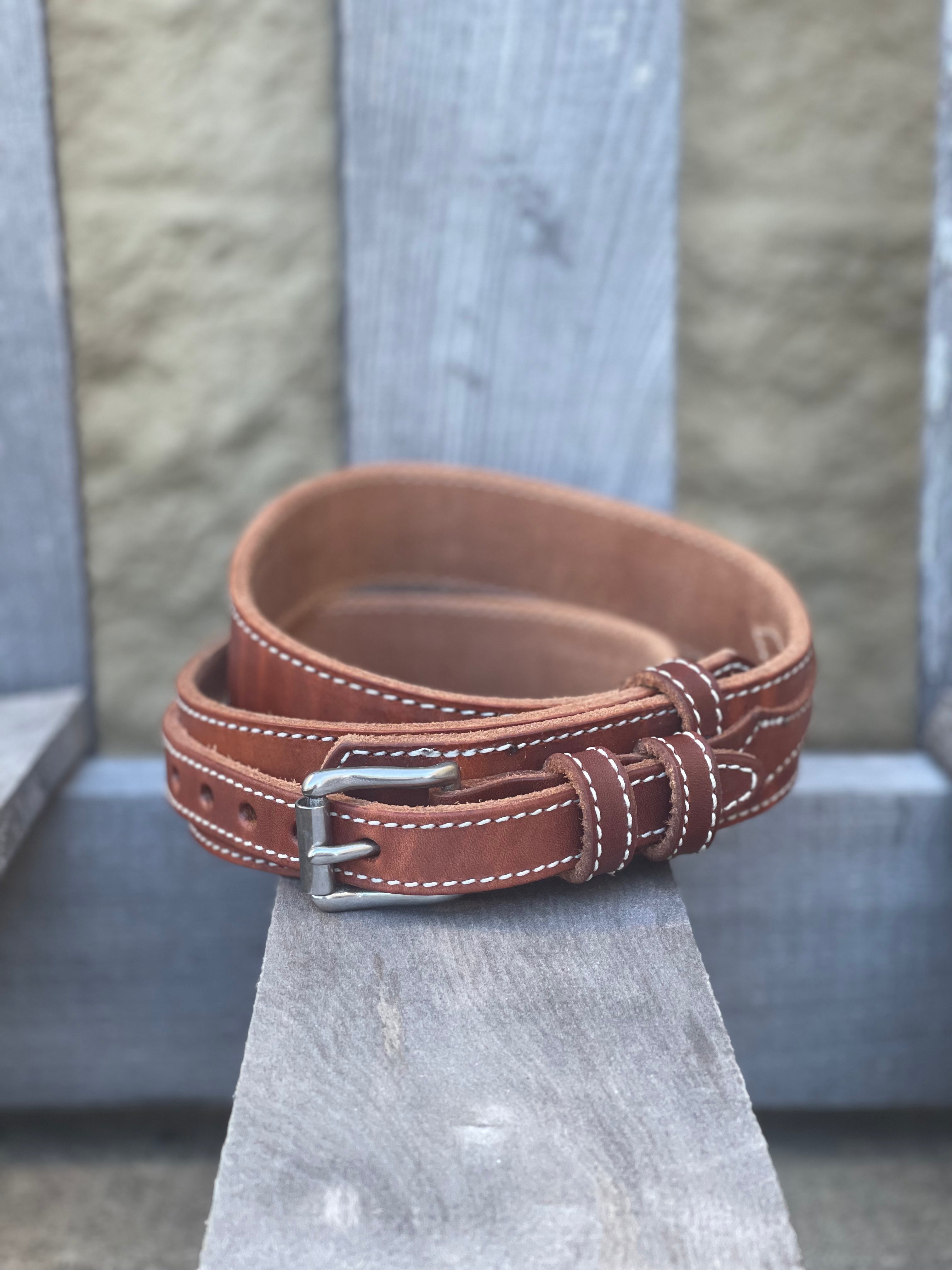 A brown oil-dipped leather belt in the ranger style with a silver buckle. Front view.