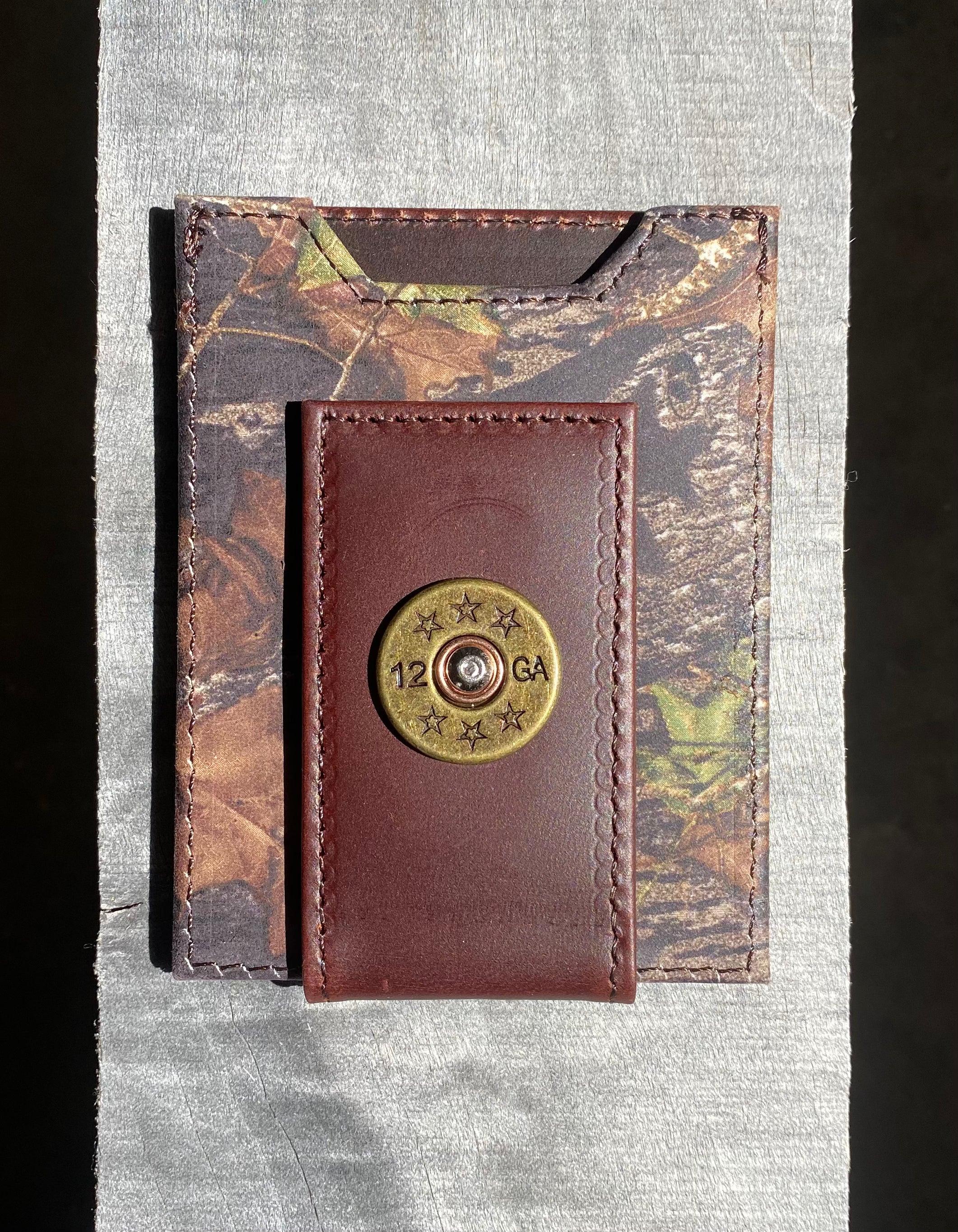 Zep-Pro Shotgun Shell Mossy Oak Camo Front Pocket Wallet front view  features brass 12 guage shot shell concho on cash magnetic closure tab.