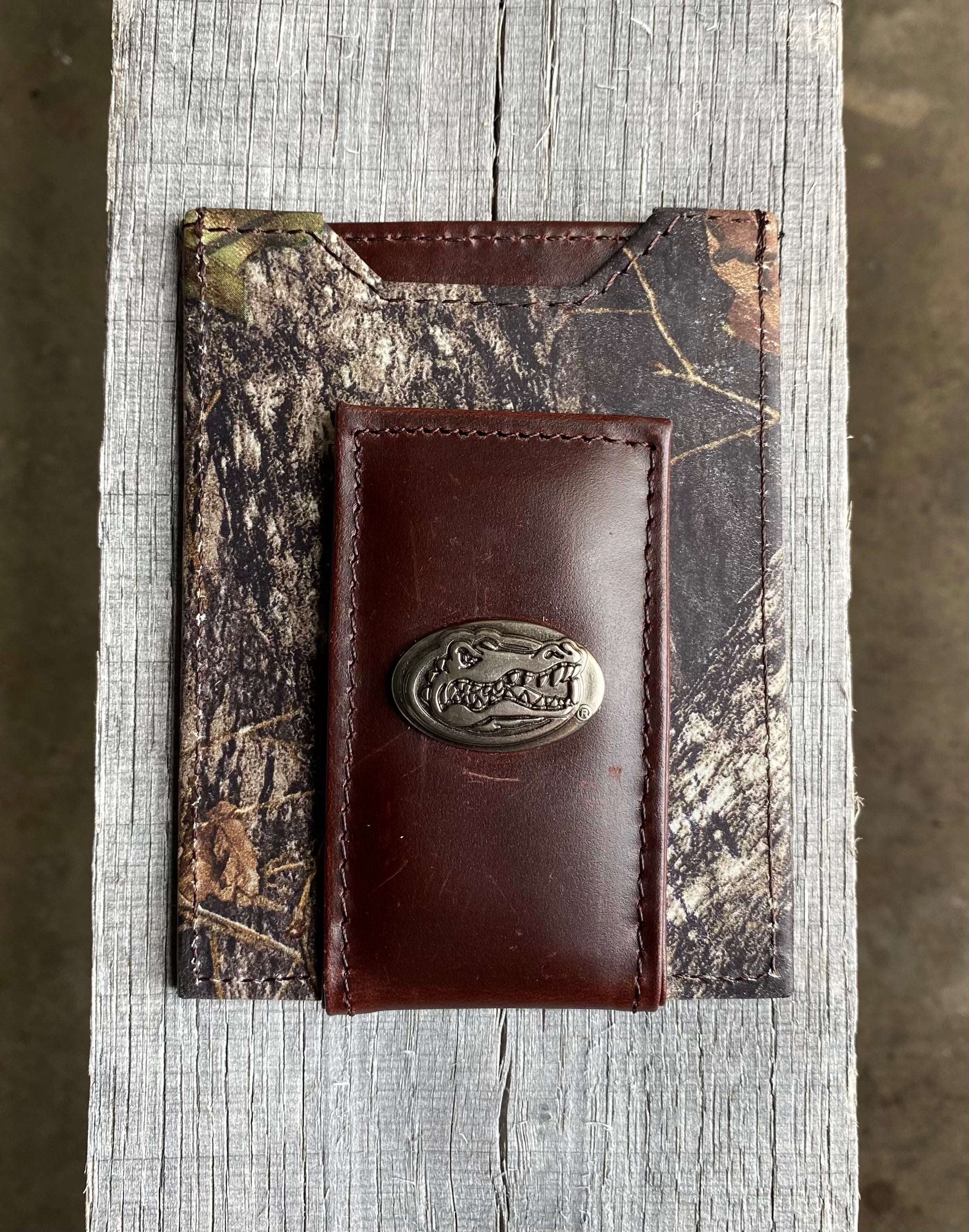 Zep Pro University of Florida Gators Mossy Oak Camo Leather Front Pocket Wallet with brass Gator logo concho on brown leather bill tab. Front view.