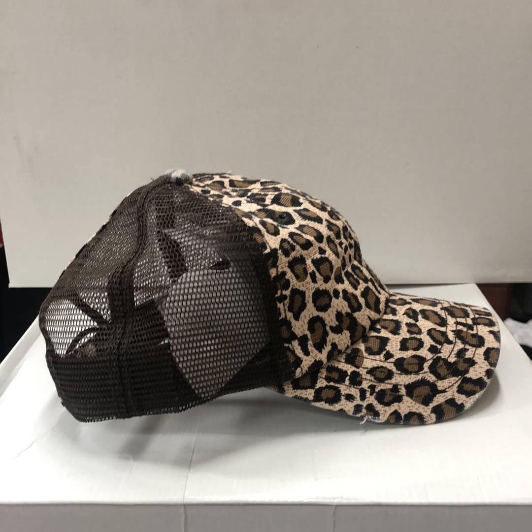 Leopard Print front and Brown mesh back distressed crisscross ponytail cap. The back has space for your hair and a adjustable Velcro back for a truly adjustable fit for your ponytails or buns. Side View 