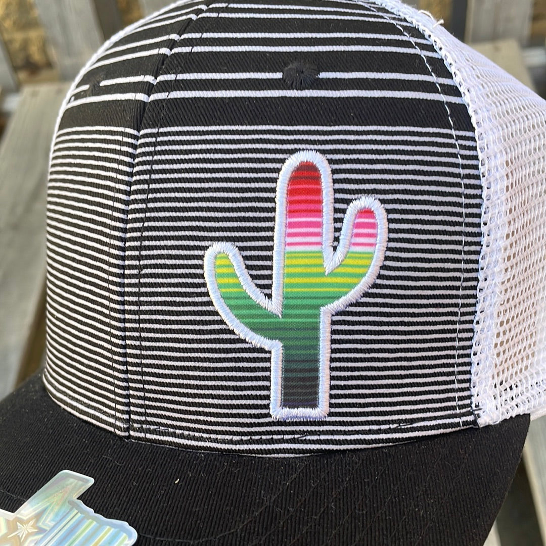 Black and White striped trucker cap with a Serape cactus patch, solid Black bill, and White mesh back. Close up view of patch.
