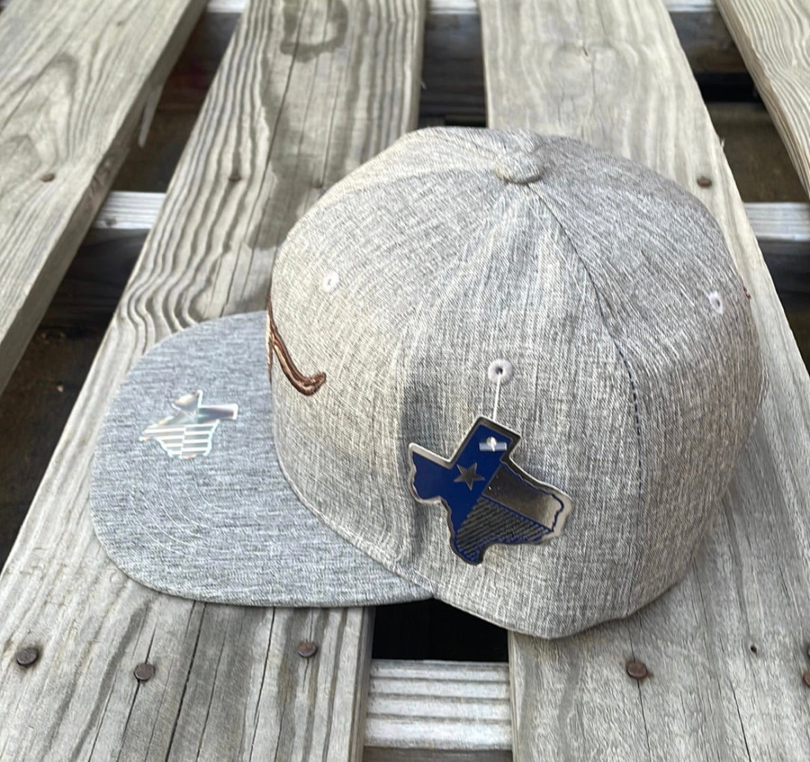 Heather Grey snapback cap with two longhorn steers embroidered on the front and a small on on the rear. Side View 