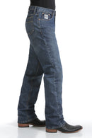 Side view of Cinch White Label medium wash jeans. Shows detail of right front coin and hip pockets, back pocket, and relaxed fit with stack on boots.