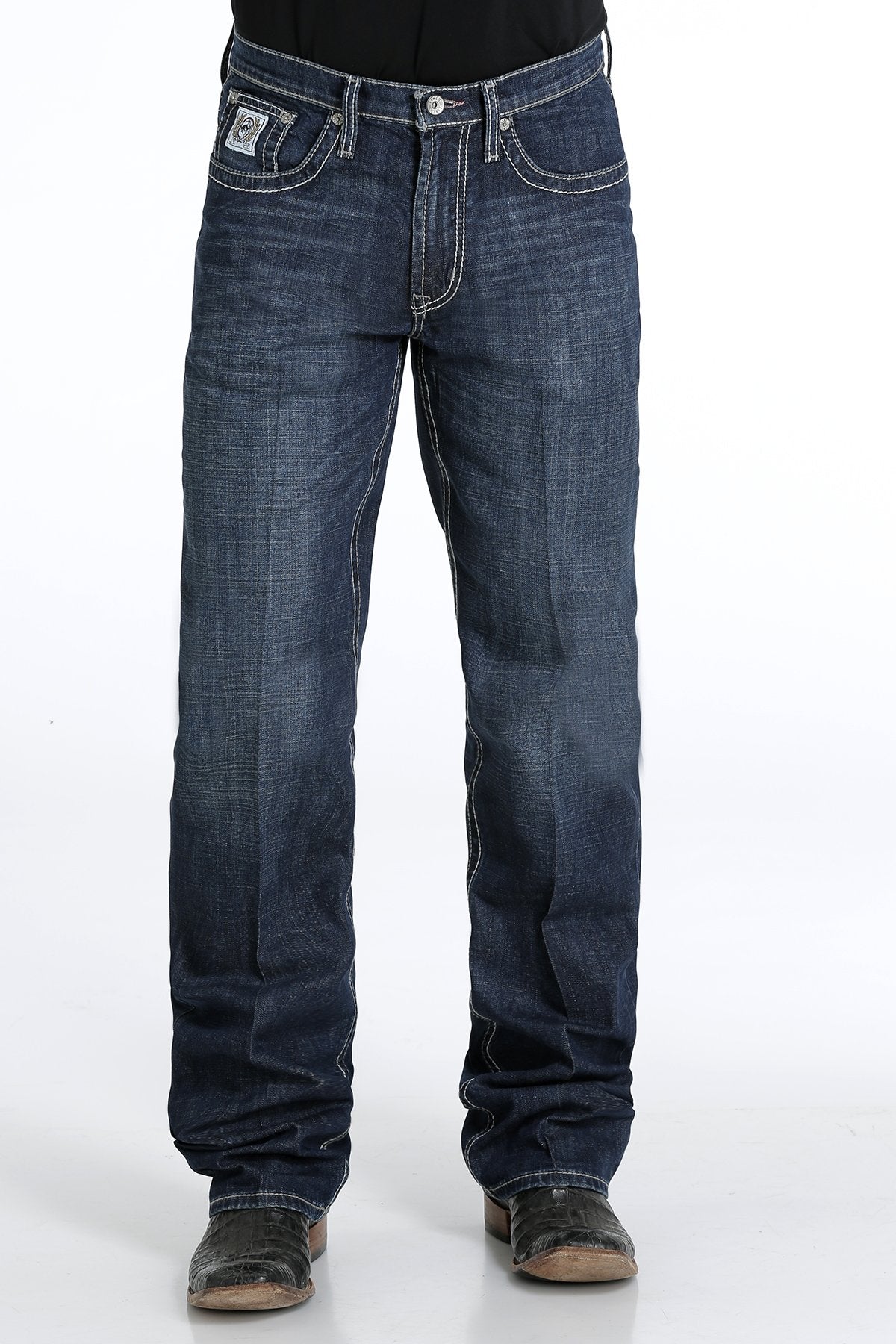 Men's White Label Dark Wash jeans front view showing detail of front pockets and zipper. Also shows relaxed  fit and stack on boots.