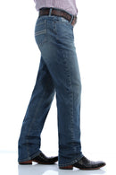 Side view of Cinch Silver Label Medium Stone wash jeans. Shows detail of right front coin and hip pockets, back pocket, and slim fit with straight leg on boots.